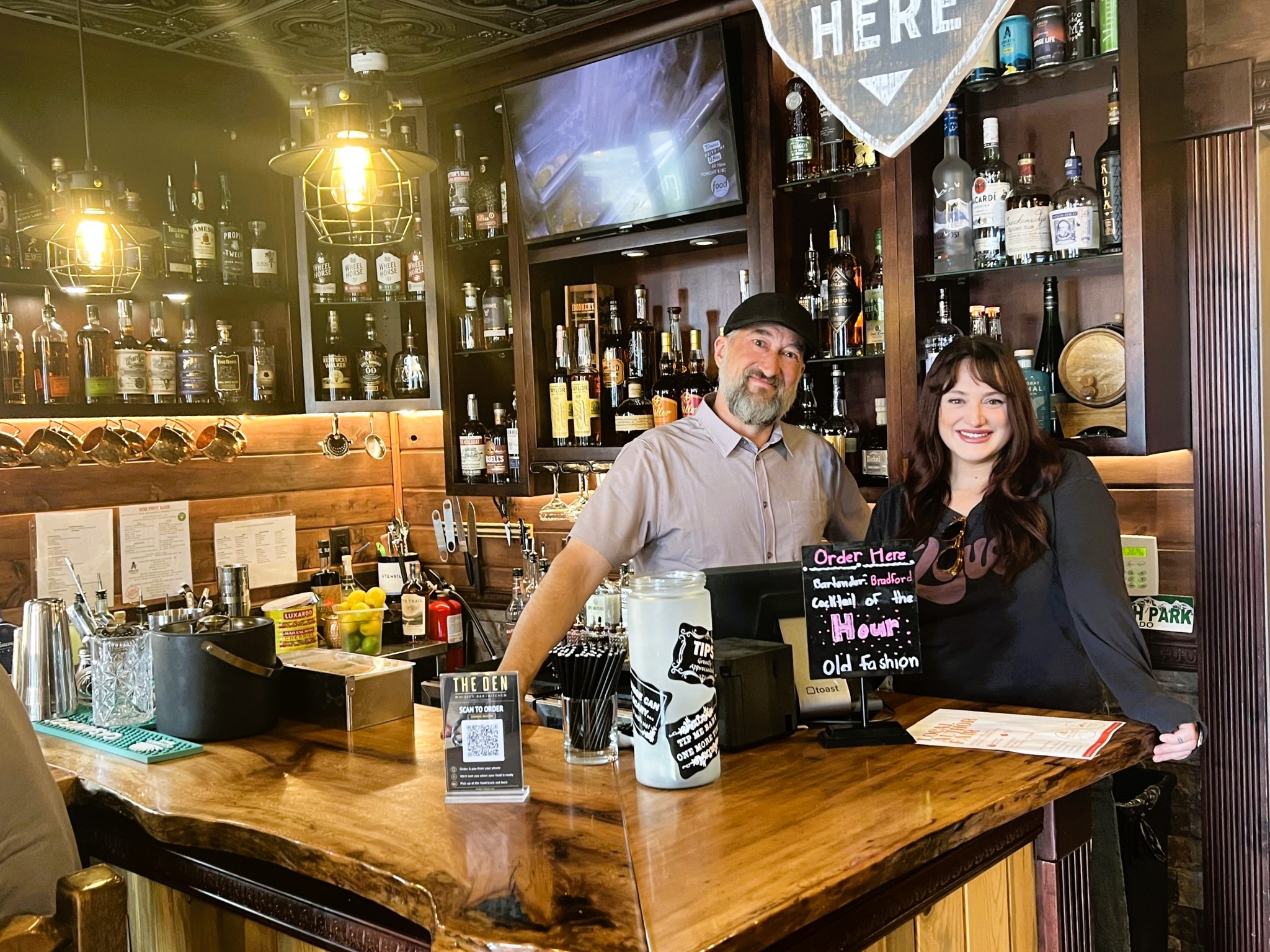 The welcoming team behind the bar at The Den